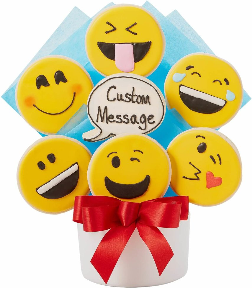 A child holding a custom emoji cookie bouquet