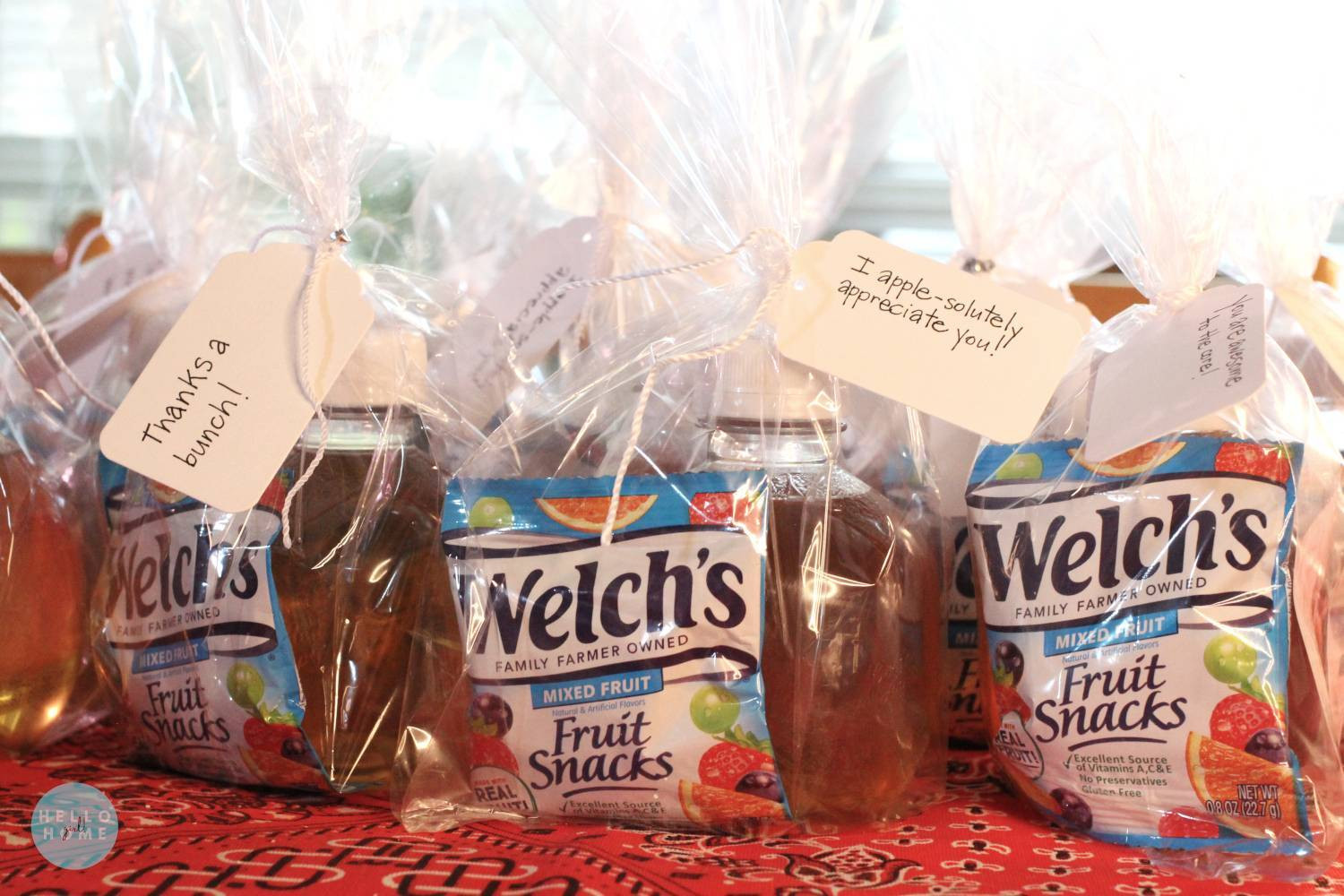 alt text: A beautifully arranged fruit basket with a variety of colorful fruits and a small jar of honey.