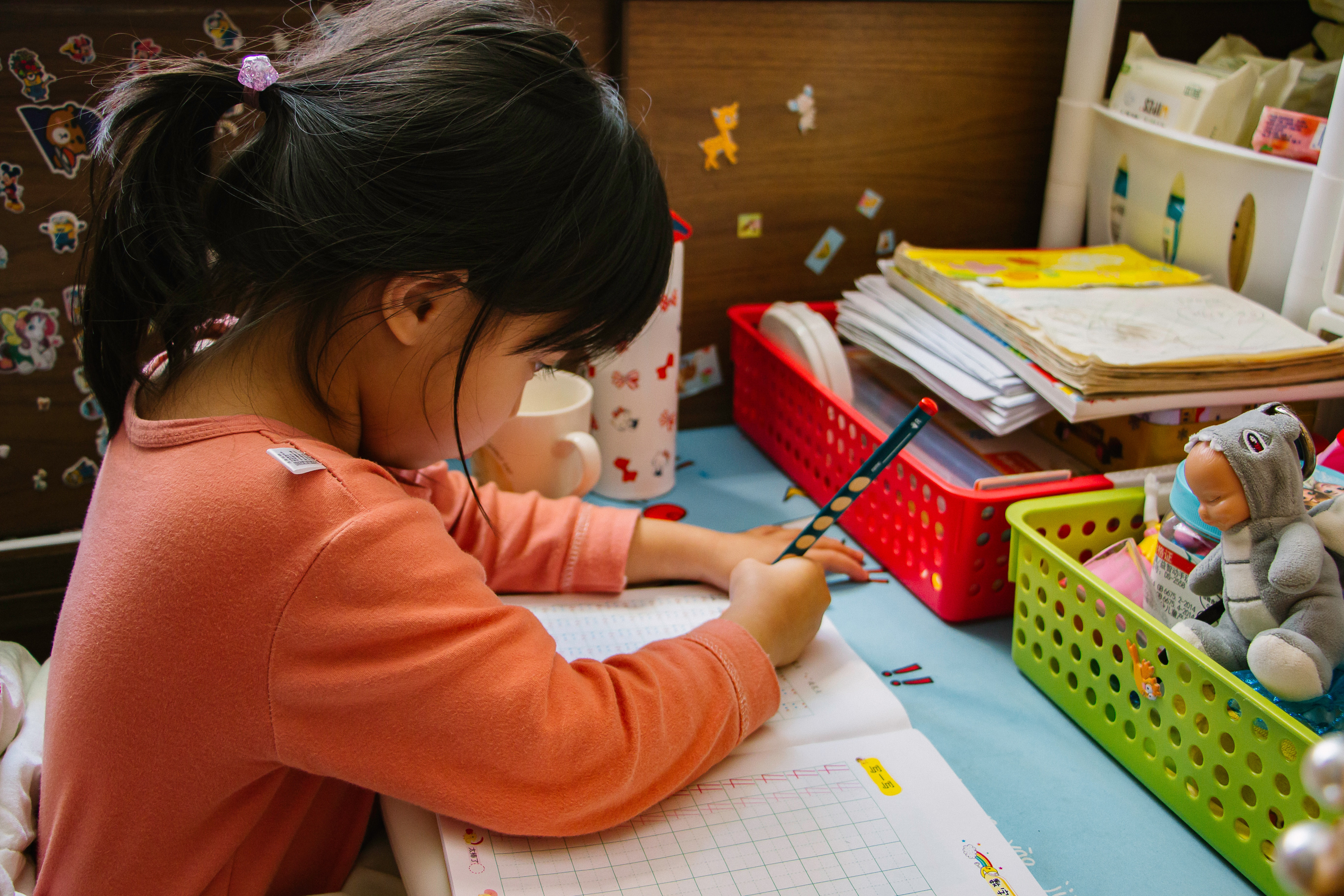 alt text: Child writing in a notebook