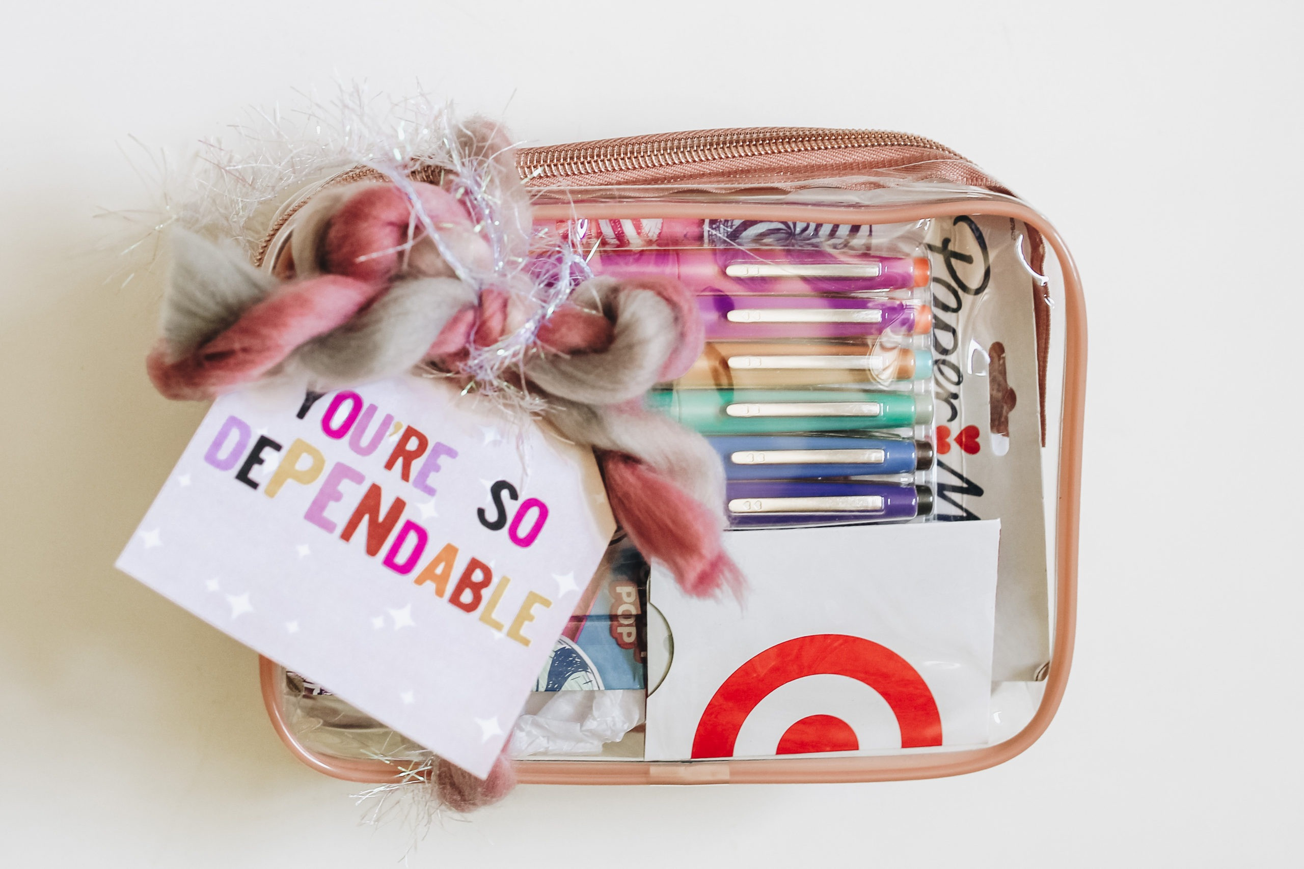 alt=A collection of colorful Flair pens arranged in a clear pouch, ready to be gifted.