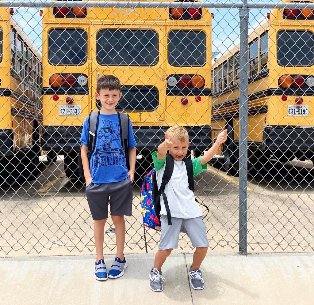 Children on a school bus giving gifts to the driver