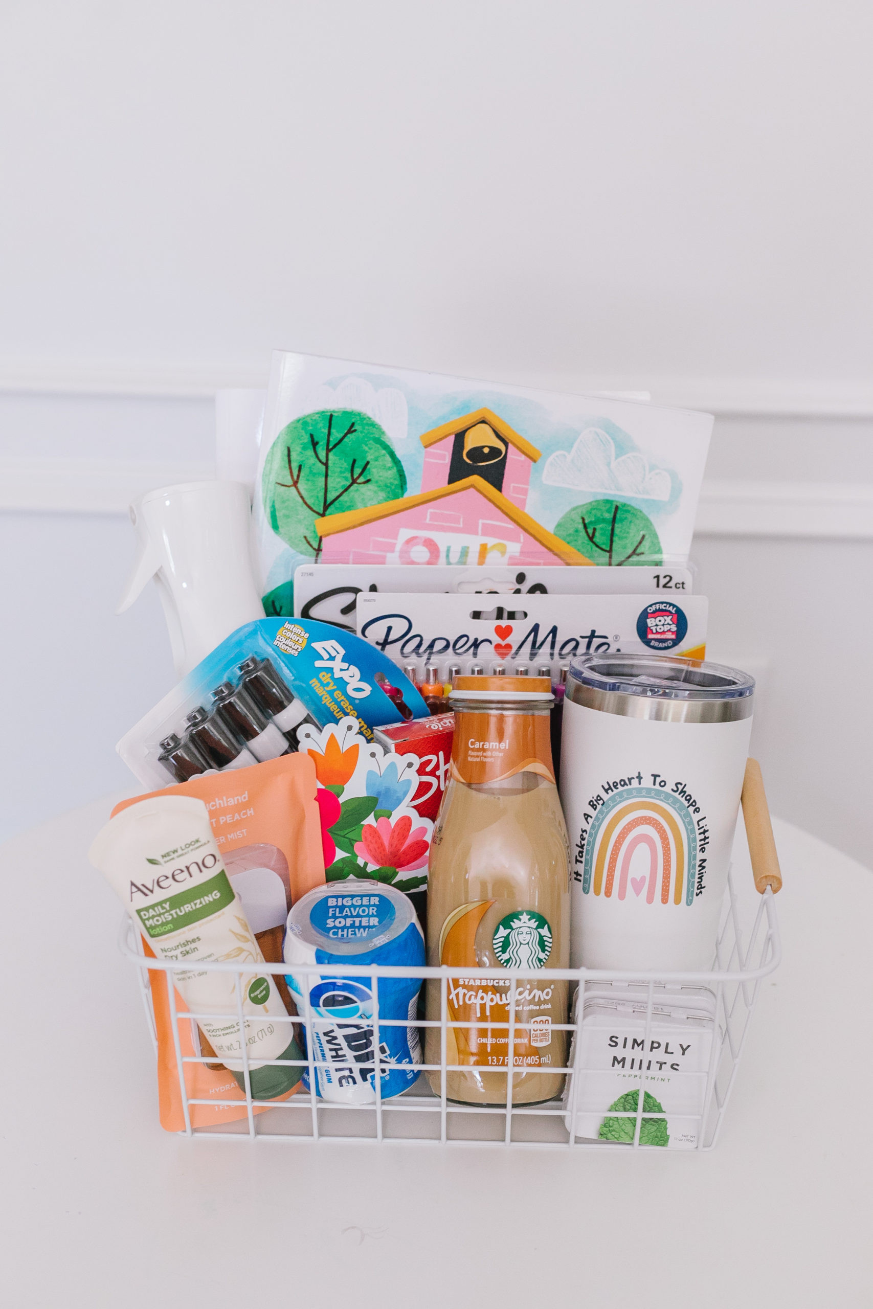 Colorful pens and highlighters in a teacher gift basket