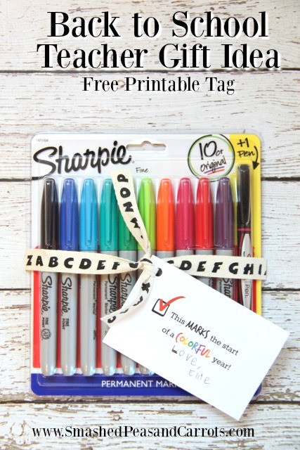 Colorful sharpies arranged with a printable gift tag for a teacher's back-to-school gift.