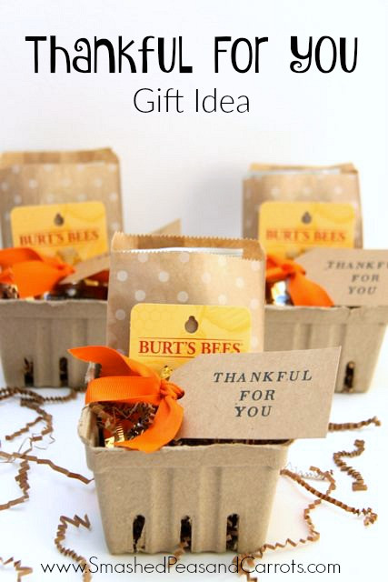 Fall-themed teacher appreciation gift basket with apples, pumpkin spice candle, and cozy blanket.