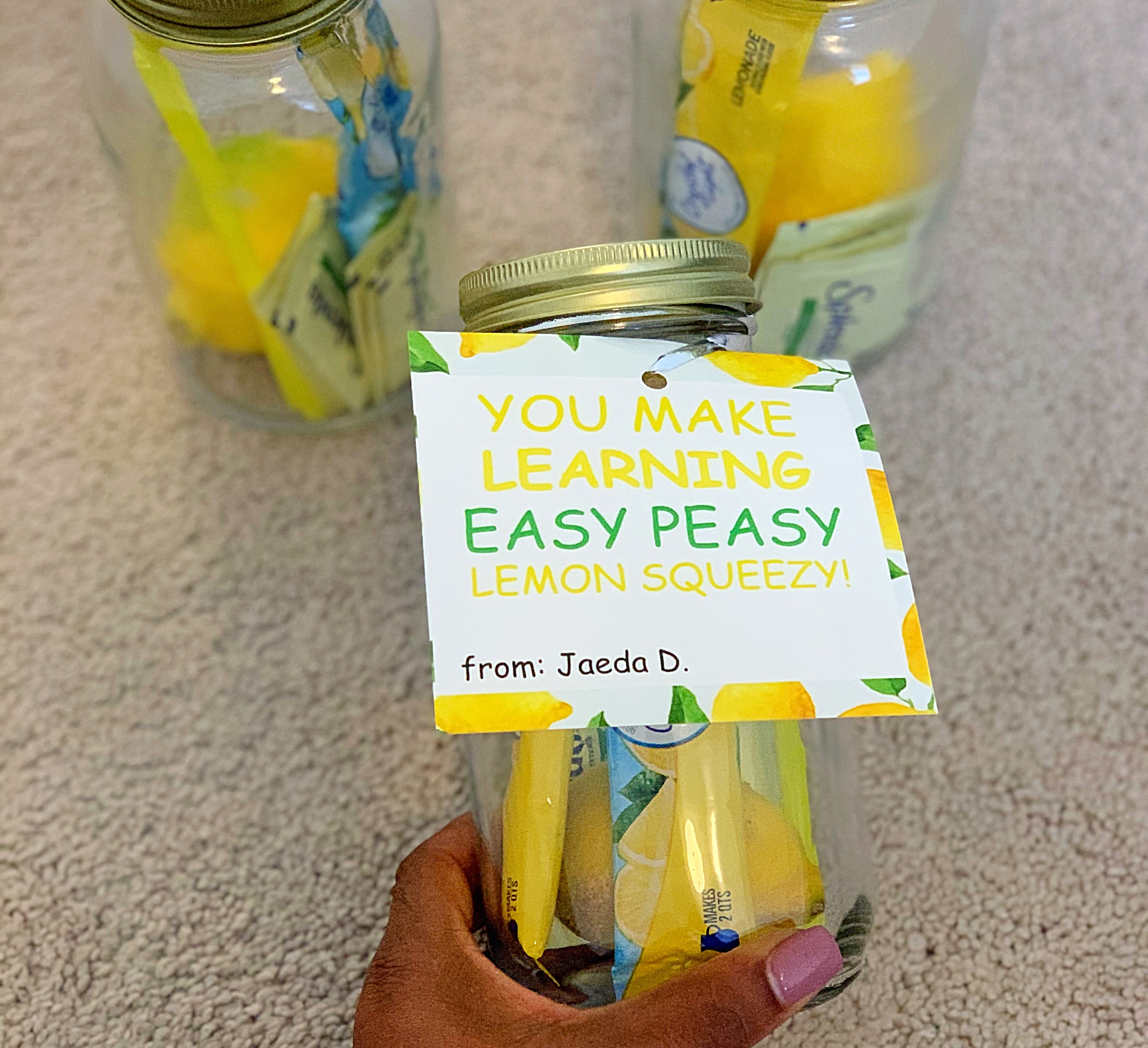 Lemonade in a mason jar with lemons and straws.
