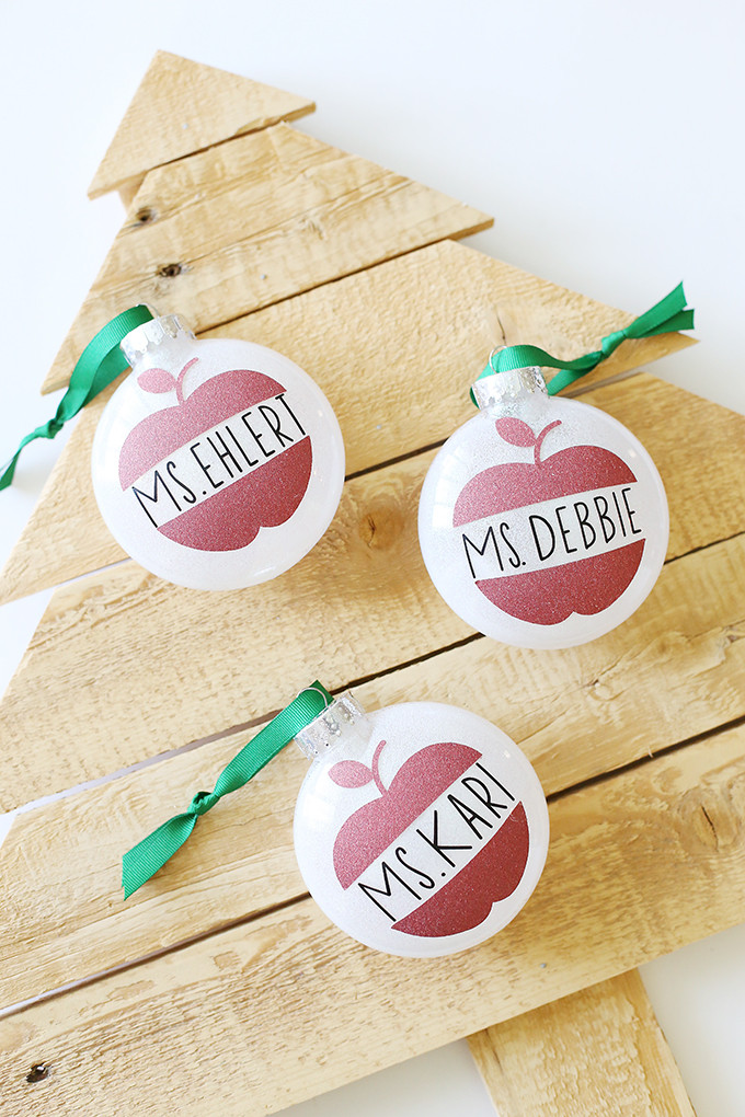 Personalized tumbler with teacher's name and apple design.