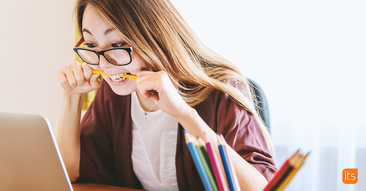 alt: A student looking anxious while biting a pencil.